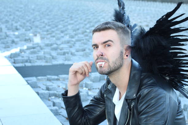 istock Futuristic vampire with blacks wings and leather jacket 1301563460