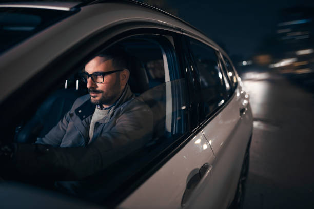 istock Handsome caucasian driving car at night 1301564327