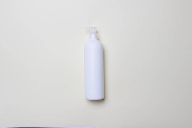 istock white bottle with detegrent on colored paper background 1301565046