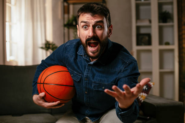 istock Man watching sports game on tv. 1301565777
