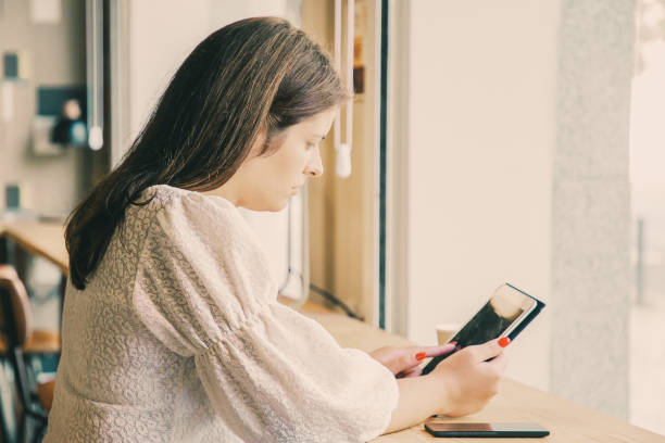 istock Focused young Caucasian woman using tablet 1301566590