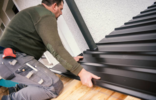 Metal roofing - roofer working on the house roof