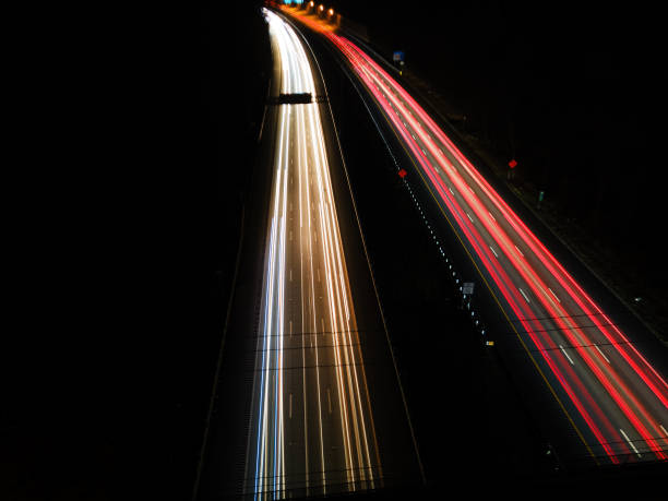 istock Streaking Lights from Cars on Highway at Night 1301570032