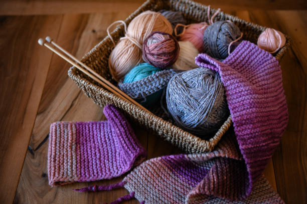 istock Accessories for knitting in basket ( yarn, needles) and scarf 1301570797
