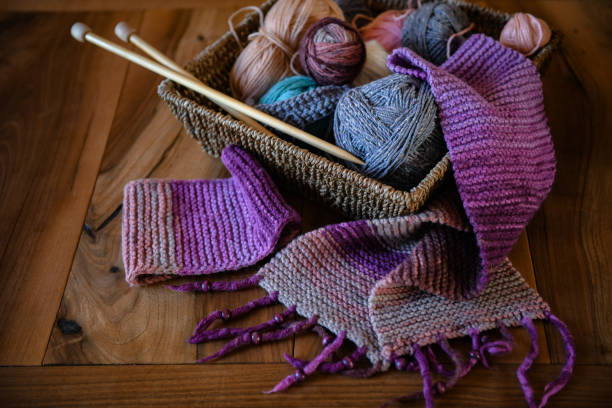 istock Accessories for knitting in basket ( yarn, needles) and scarf 1301570974
