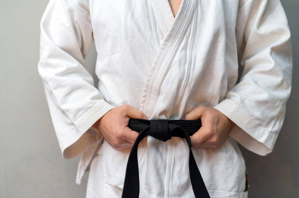 istock A man in kimono is holdong his black belt 1301572015