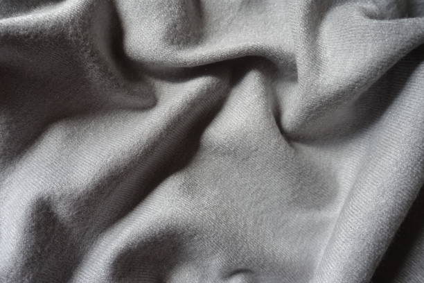 istock Soft folds on simple gray jersey cotton fabric 1301574136