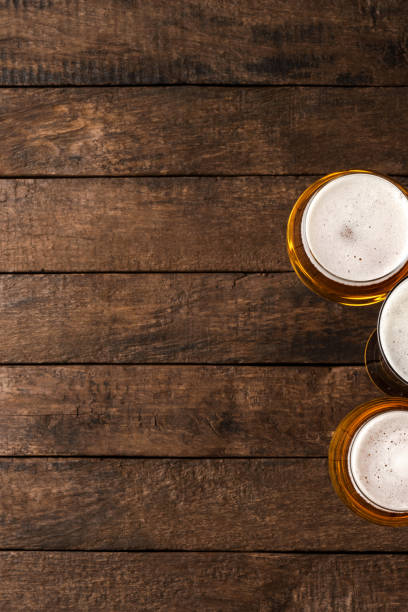 istock Beer glasses on wooden table with copyspace. 1301576180