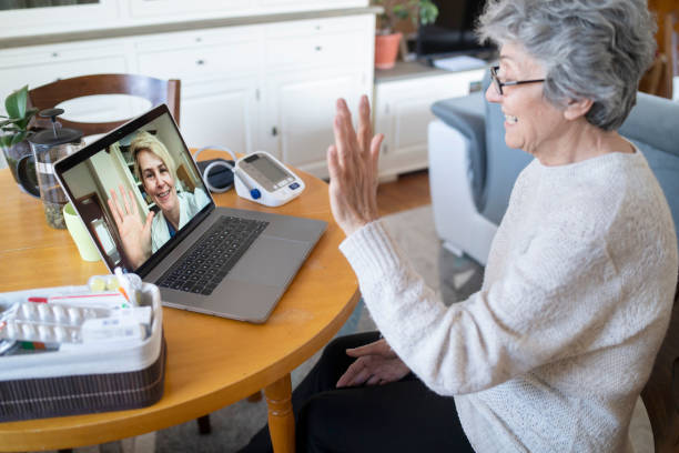 Online consultation with a doctor Senior woman having online consultation with her doctor in a video call blood pressure medication stock pictures, royalty-free photos & images