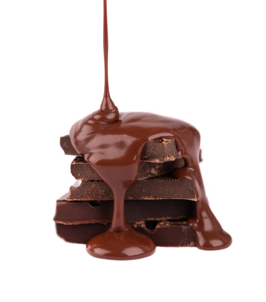 istock Chocolate pieces stack and chocolate syrup isolated on white background. Close up. 1301576819