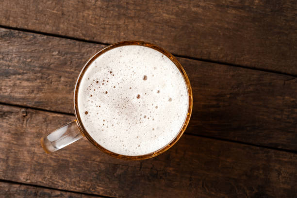 istock Beer glass on an old wooden table. Top view 1301577577