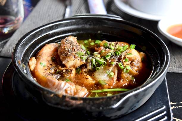 istock The dish of fish on black earthen pot. 1301577698