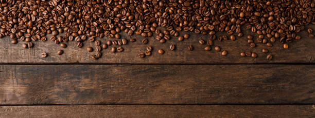 istock Coffee beans on wooden background with copyspace. 1301577863