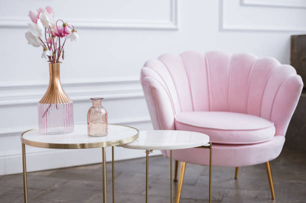 istock Pink flowers in a glass vase on a marble dressing table. Light interior. 1301580627