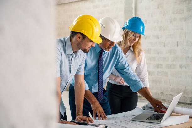 istock Businessman talking to architects at construction site 1301580996