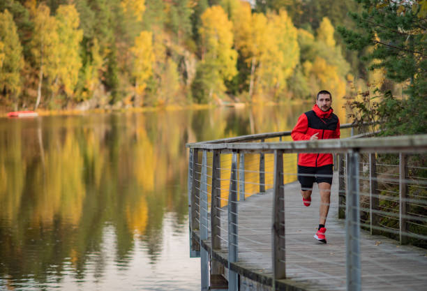 istock Running by the lake, lonely man. 1301582003