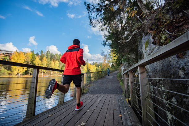 Sportsman running on bridge in nature. stock photo