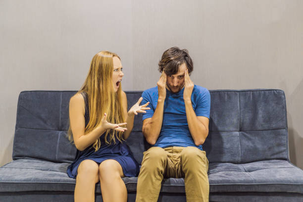 istock Young couple swears on the couch. Emotional intelligence concept 1301582093