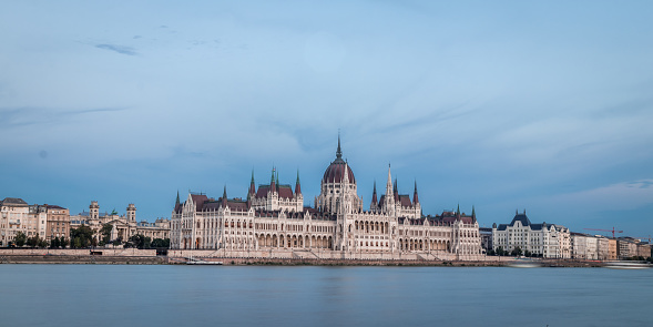 Budapest,Hungary-December 17th 2014:Danube river tourist boats terminal,embankment traffic ,at the opposite bank Buda Castle against colorful sunset skies