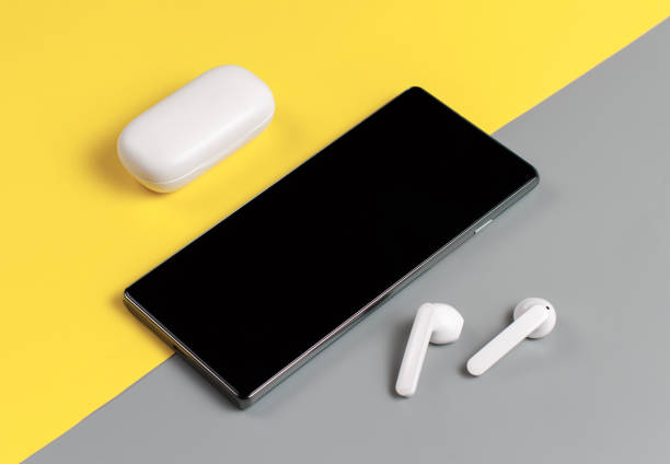 Smartphone and white wireless earphones