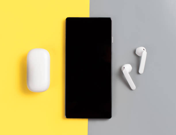 istock Smartphone and white wireless earphones 1301585338