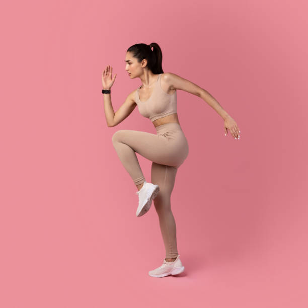 istock Young Woman Running And Exercising Isolated On Pink Background 1301586042