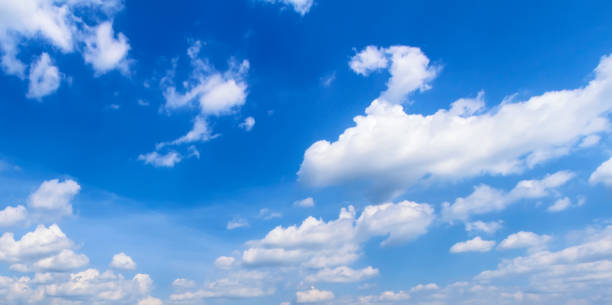 istock Beautiful sunny blue sky background with white clouds 1301586240