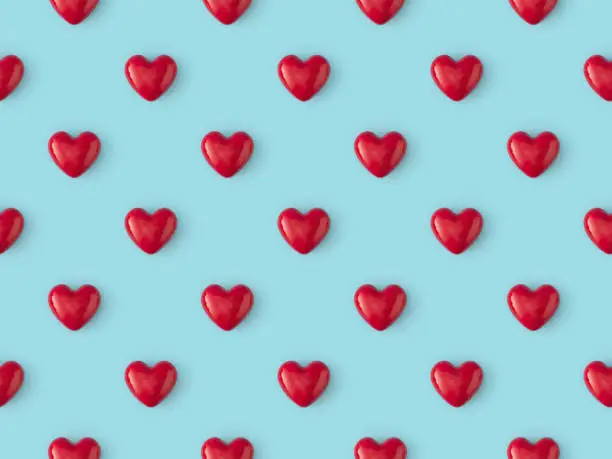 Photo of Seamless repetitive Red Heart Shape on blue background