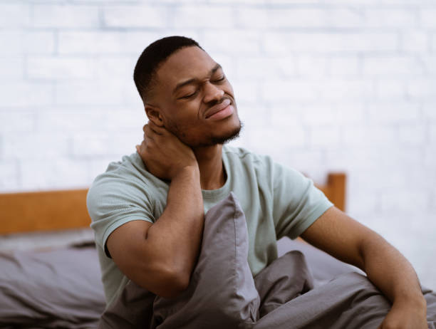 istock Black Man Massaging Neck Suffering Osteoarthritis Waking Up In Bedroom 1301587496