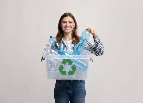 istock Waste For Recycling. Cheerful Young Woman Carrying Container Box With Plastic Bottles 1301587540