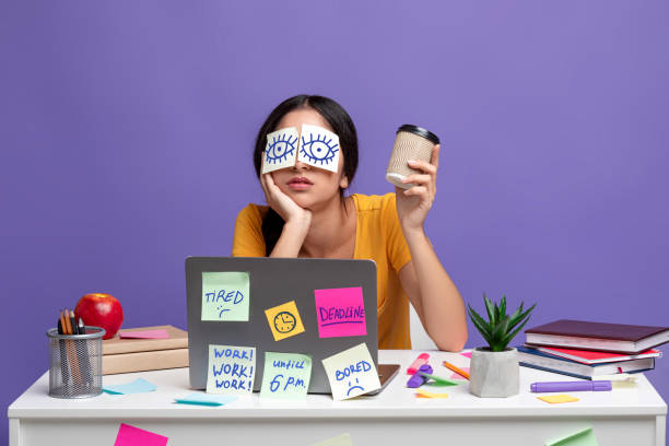 istock Tired indian woman sitting at desk with sticky notes 1301590100