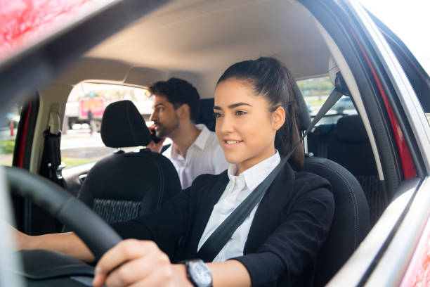 istock Taxi driver with passenger at back seat. 1301590367