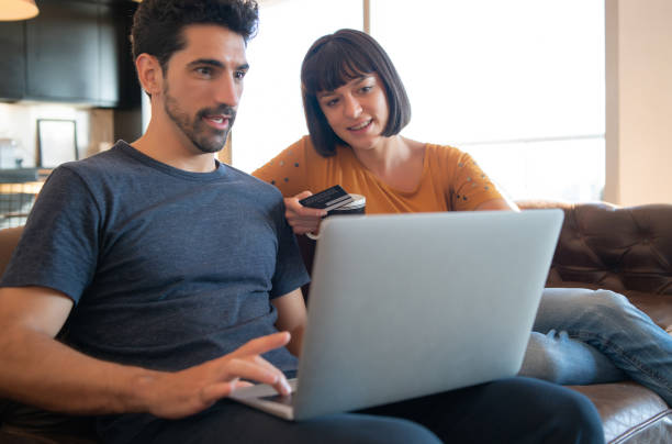 istock Young couple shopping online from home. 1301590451