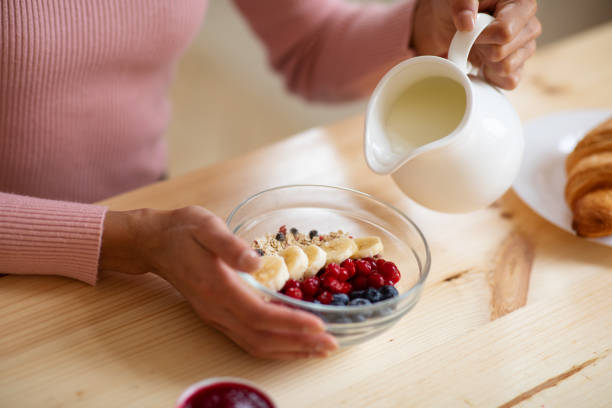 Healthy Breakfast. Unrecognizable Woman Eating Muesli With Fruits, Closeup Shot