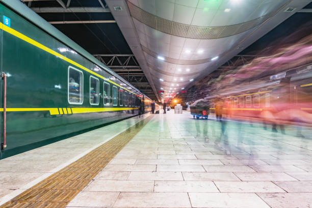 istock Passenger trains stand by the platform at evening time. 1301592594