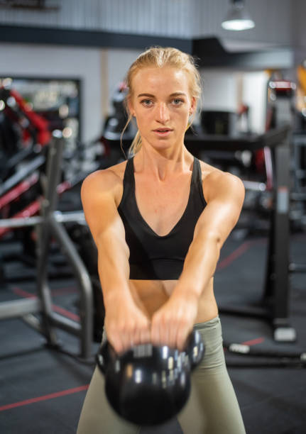 istock Fit young woman doing kettlebell swings during a gym workout 1301593424