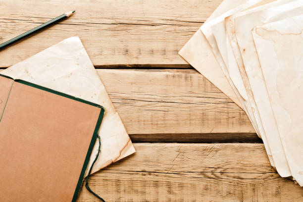 istock Vintage paper. Old notepad on a wooden background. Copy space 1301594107