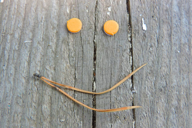istock smiley face on the rough surface of boards 1301594282