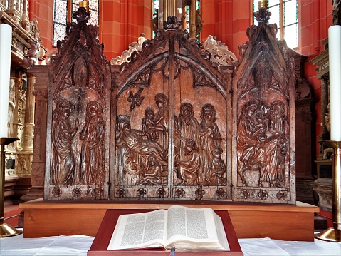 Wood carving on the main altar of the collegiate church. Behind it is a canopy grave of the Wertheim counts.