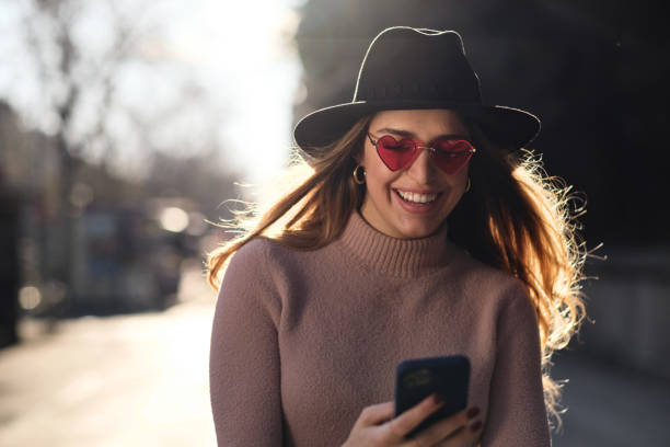 istock Young woman using her mobile phone outdoors. 1301595158