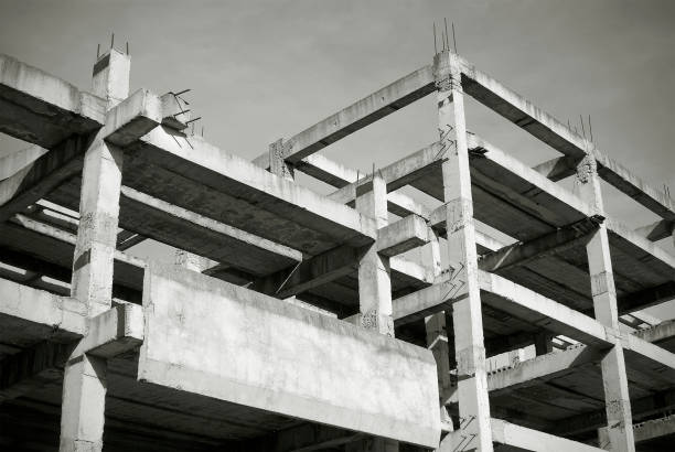 Unfinished and abandoned concrete building in black and white.