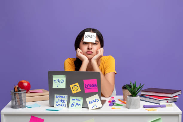 istock Tired indian woman sitting at desk with sticky notes 1301597890