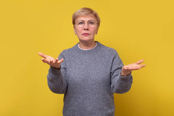 istock Senior mother shrugging raising palms aside questioned arguing. 1301598437