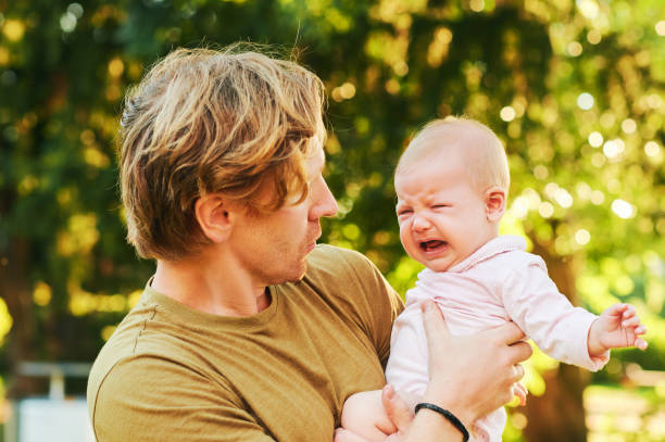 istock Young father trying to calm down crying baby 1301599465