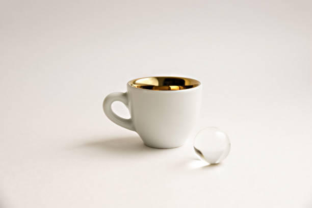 White espresso coffee cup and transparent ball on a white background.
