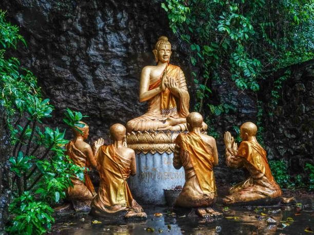 istock Golden Buddhist statues on a densely forested hillside. Luang Prabang, Laos. 1301600809