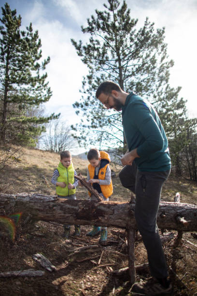 istock Young man brought his two sons in the forest to teach them about nature 1301602664