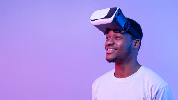 istock Smiling African American Guy Wearing VR Glasses And Looking Aside, Neon Light 1301602819