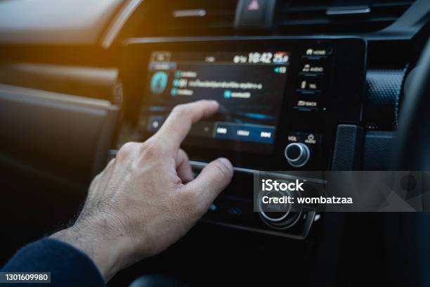 The Driver Using Touch Screen Monitor In The Modern Car Stock Photo - Download Image Now