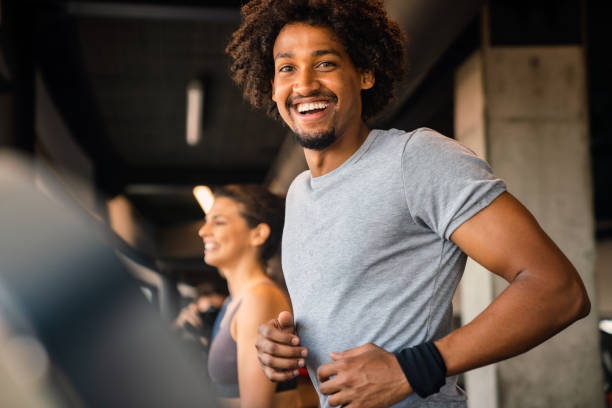 istock Fit man exercising at the gym on a machine 1301610816